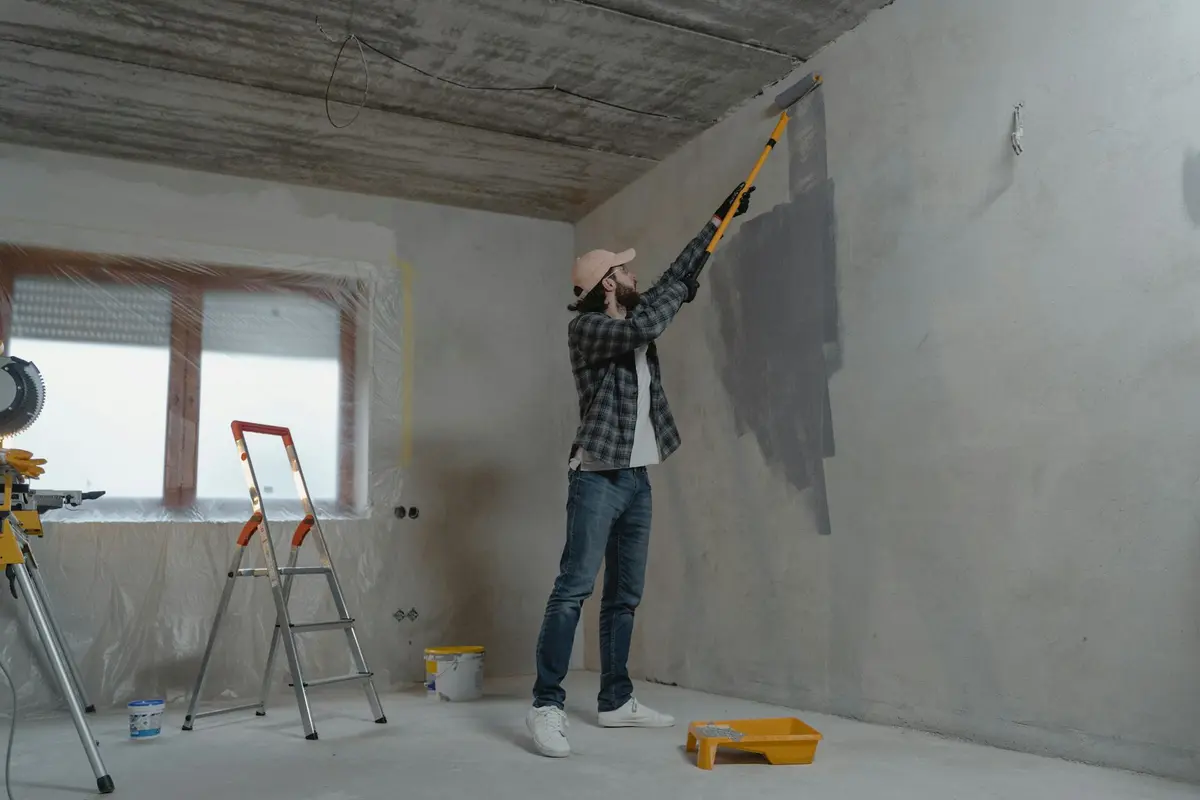 Professional painter working on an interior wall in Dubai